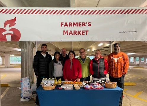 Stellar Bank employees standing with members of the American Heart Association at a volunteer event