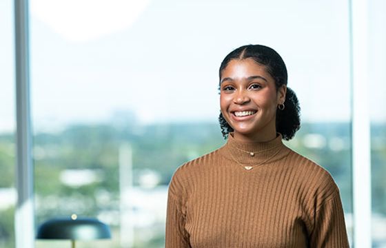 A smiling woman who has gained financial knowledge through Stellar's financial education center