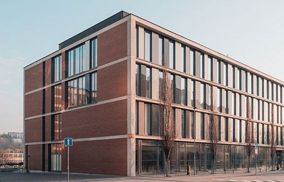 The outside of a municipal building at sunset