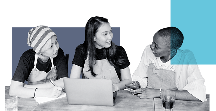 Three baristas discussing their finances at a table