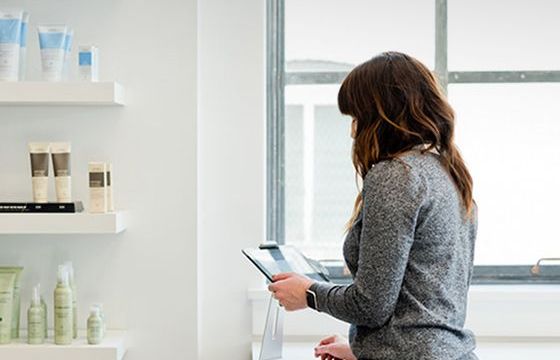 A woman looking over business statements in her skin care store