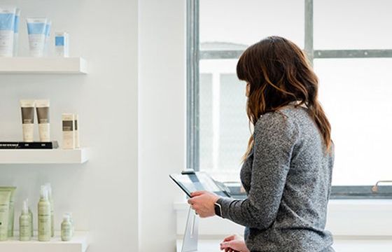 A woman looking over business statements in her skin care store