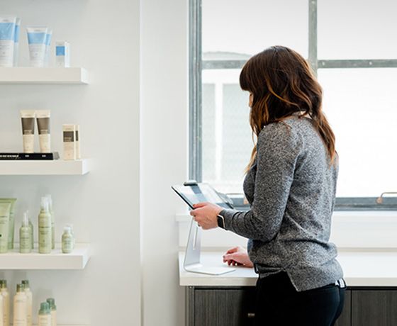 A woman looking over business statements in her skin care store