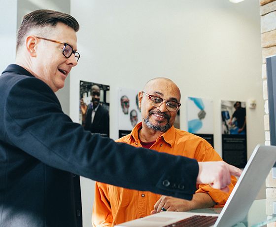 A Stellar Bank expert walking a client through treasury management services on a laptop