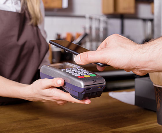 A man using his phone to scan and pay for meal with the Stellar Bank App