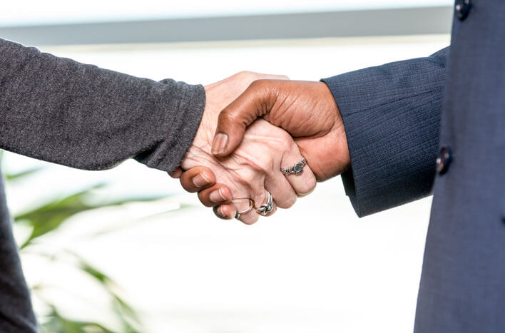 A pair of hands shaking each other