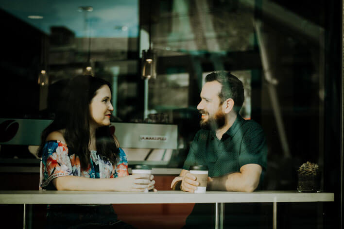 A couple having coffee while having a meaningful conversation about money