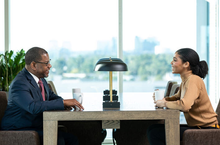 A Stellar accountant walking a young woman through their banking service options