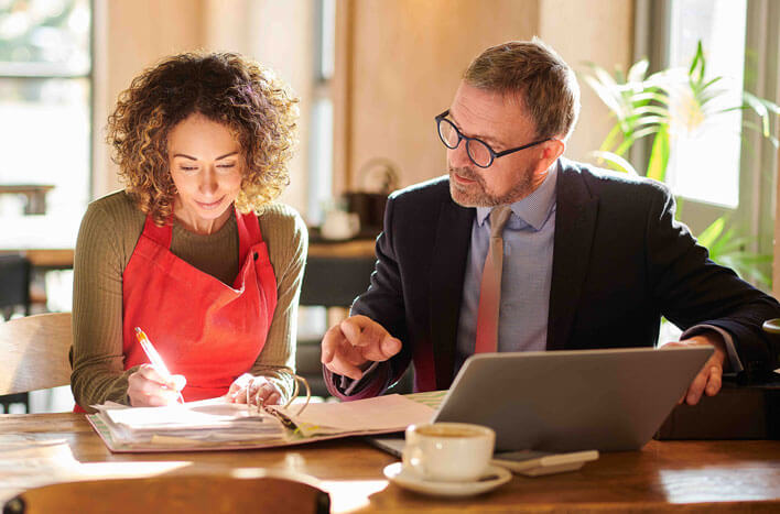 A Stellar accountant assisting a woman with her financial check-up