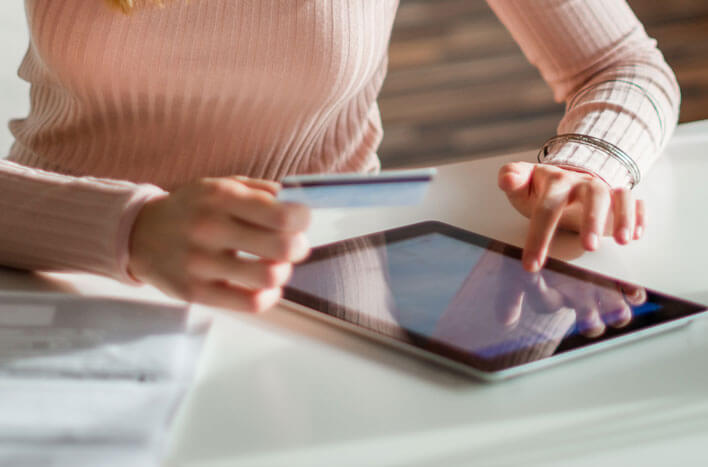 A woman about to put credit card information into her tablet
