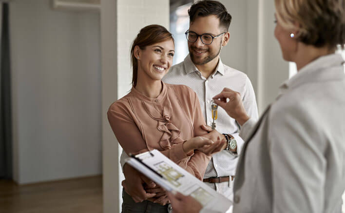 A couple being handed the keys to their new home