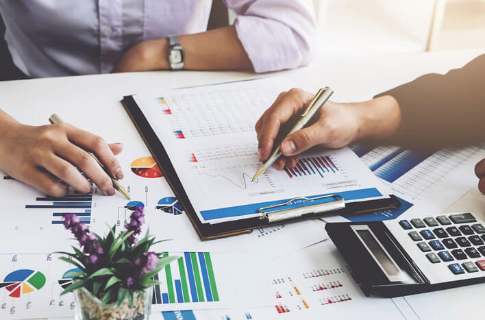 People looking over business figures at a table