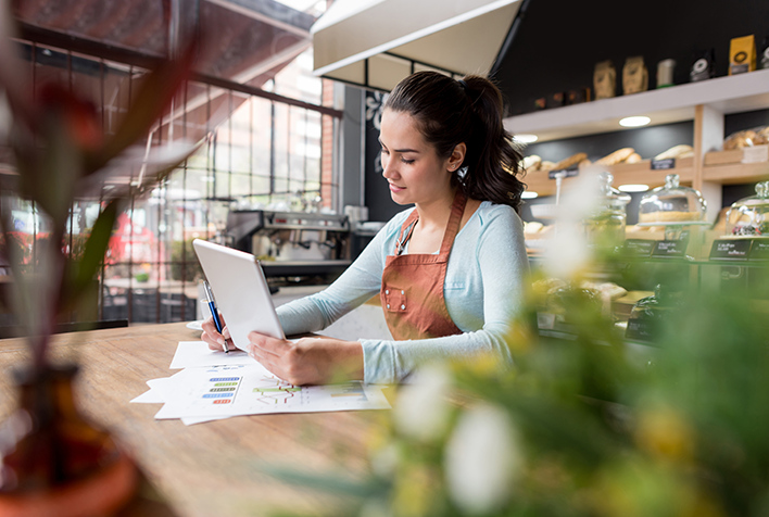 woman calculating doing books at restaurant